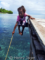 "Papua Girl's Fishing" at Arborek's jetty, Raja Ampat, We... by Henry Jager 